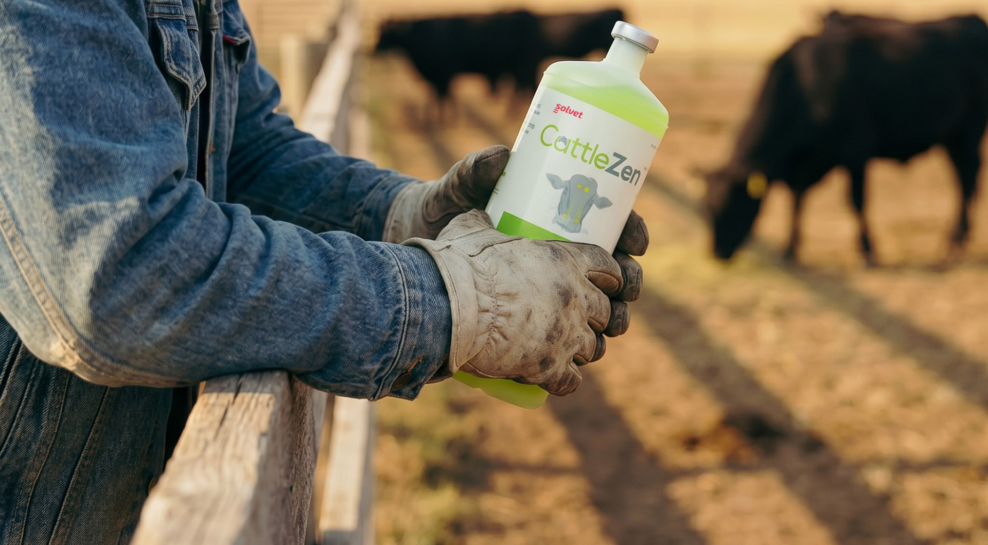 A cattle producer holding a bottle of CattleZen